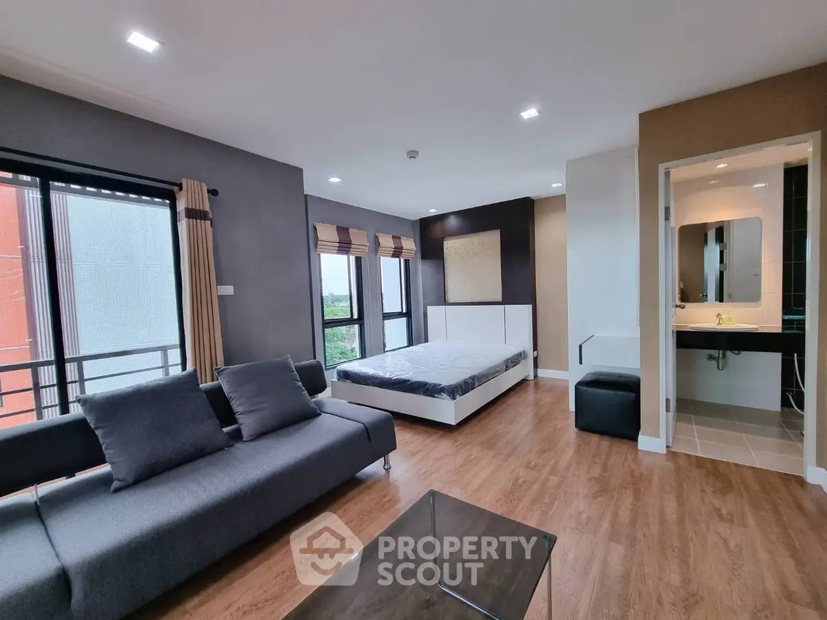 Spacious modern bedroom with large windows and stylish decor