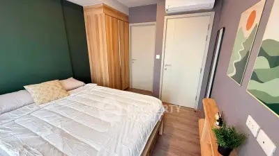 Modern bedroom with wooden accents and stylish decor in a cozy apartment.