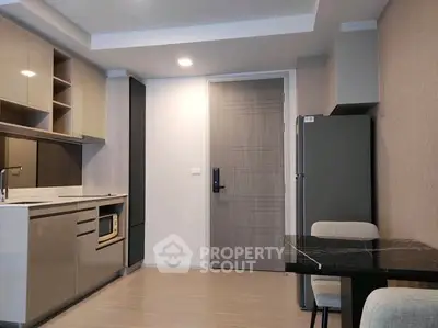 Modern kitchen with sleek cabinets and dining area in stylish apartment