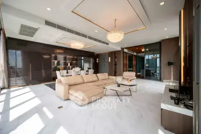 Luxurious modern living room with elegant chandeliers and spacious open layout.