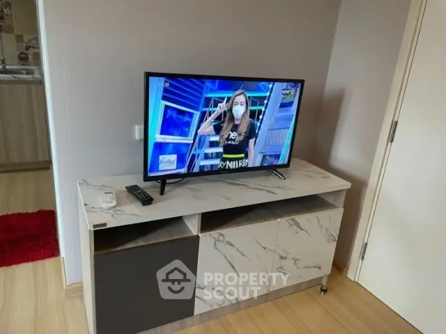Modern living room with stylish TV stand and flat-screen TV, showcasing contemporary interior design.