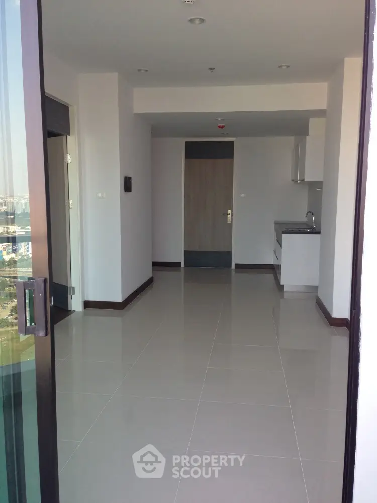 Spacious modern apartment interior with sleek kitchen and glossy tiled floors