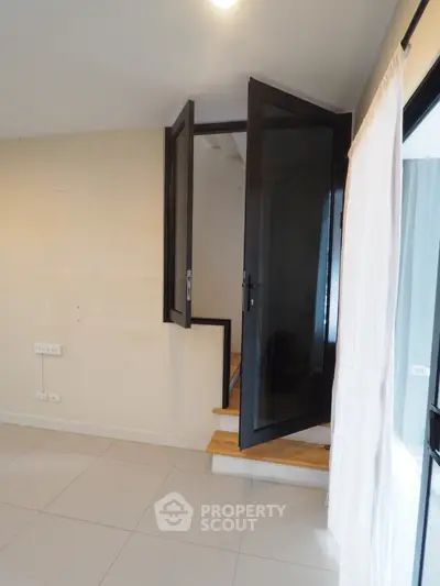Modern interior with unique elevated door design and sleek tile flooring