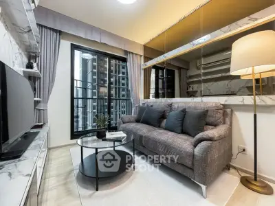 Modern living room with stylish decor and city view, featuring a cozy sofa and sleek TV setup.