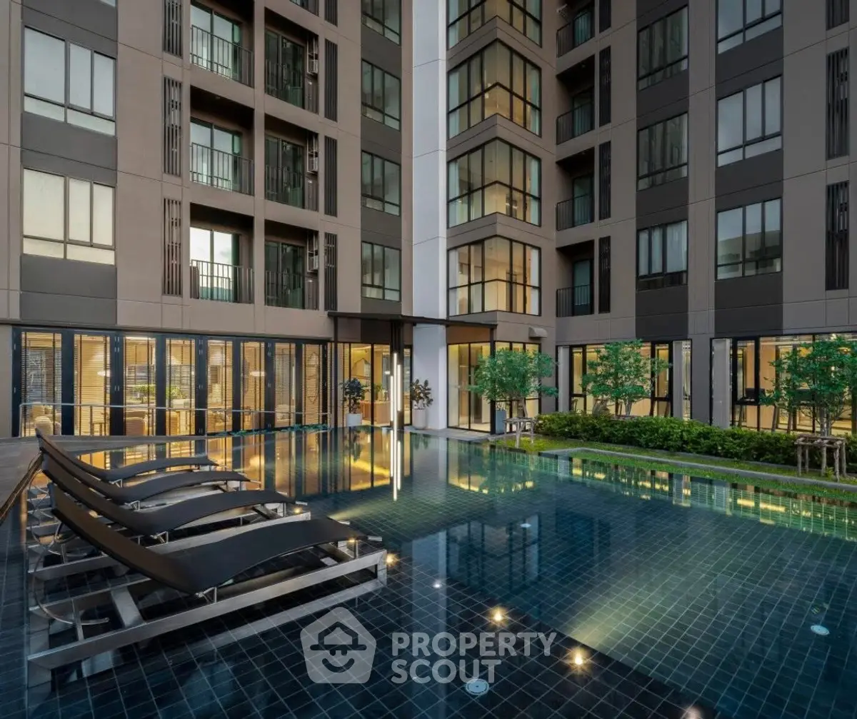Luxurious modern apartment complex with stunning pool and elegant architecture.