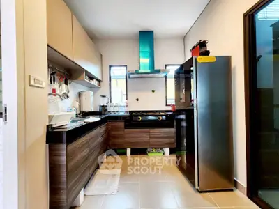Modern kitchen with sleek cabinets and gas stove in a cozy home.