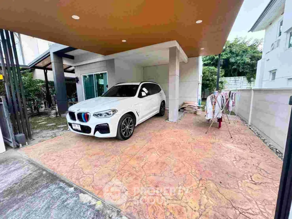 Modern home with covered parking and luxury SUV in driveway