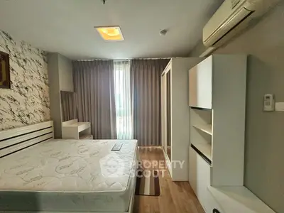 Spacious bedroom with modern furnishings and natural light