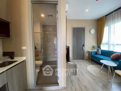 Modern apartment interior with cozy living room and compact bathroom