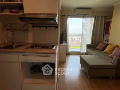 Cozy apartment with compact kitchen and bright living area with balcony view