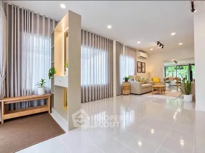 Spacious modern living room with elegant decor and large windows for natural light.
