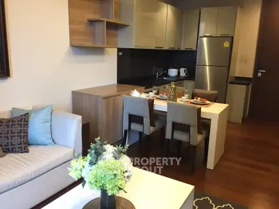 Modern open-layout living room and kitchen with stylish furniture and appliances