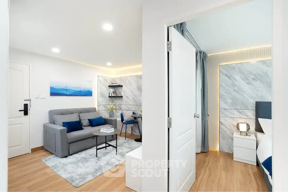 Modern apartment interior with cozy living room and stylish bedroom, featuring elegant decor and natural lighting.
