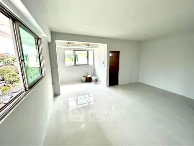Spacious unfurnished room with large windows and tiled flooring, perfect for customization.