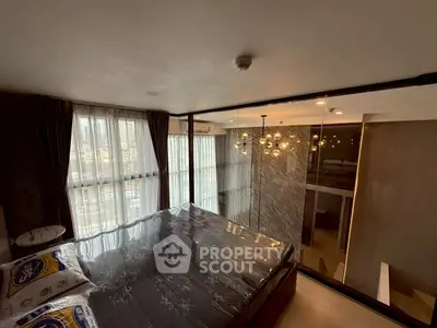 Luxurious bedroom with floor-to-ceiling windows and modern lighting in high-rise apartment.
