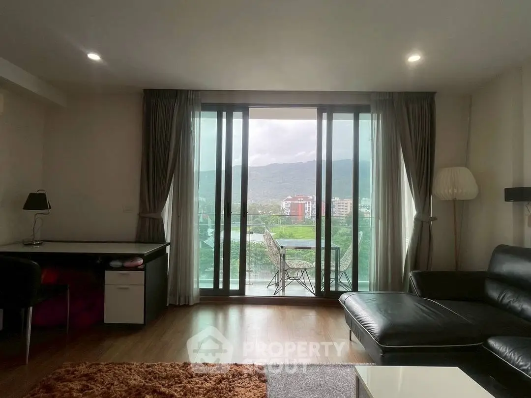 Modern living room with balcony and scenic mountain view