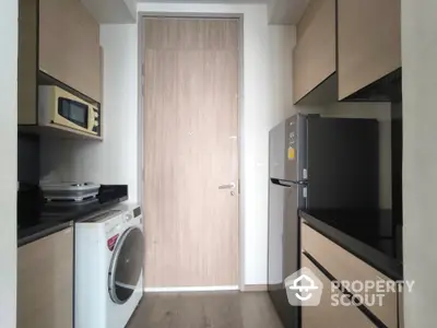 Modern kitchen with sleek appliances and wooden cabinetry