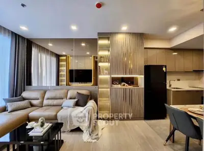 Modern living room with elegant decor and open kitchen layout in luxury apartment.