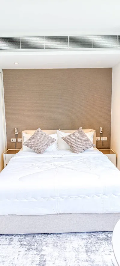 Luxurious bedroom with modern design and plush bedding in a high-end apartment.