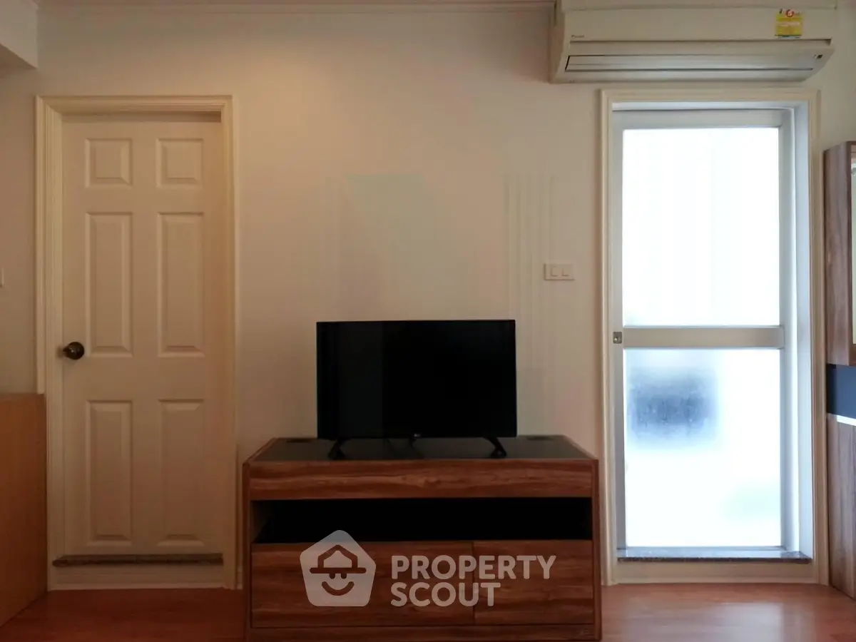 Modern living room with sleek TV stand and air conditioning unit
