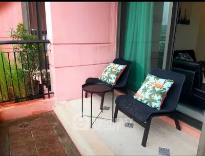 Charming balcony with cozy seating and tropical-themed cushions, perfect for relaxation and enjoying outdoor views.