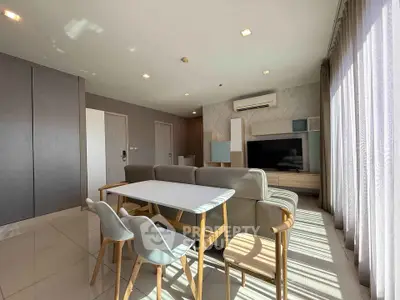 Spacious modern living room with stylish furniture and abundant natural light.