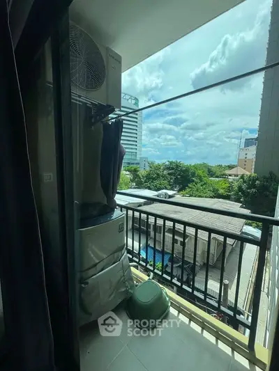 Charming balcony view with cityscape and lush greenery, perfect for relaxation and enjoying the outdoors.