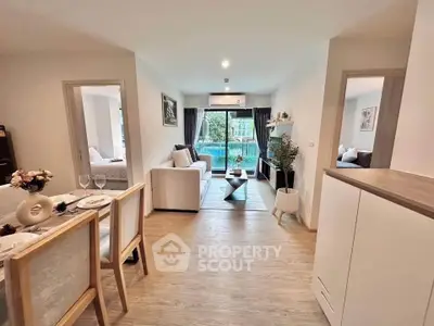 Modern open-plan living room with dining area and balcony view