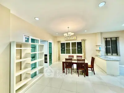 Spacious dining area with elegant chandelier and modern open kitchen layout