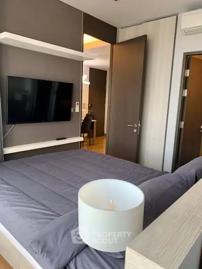 Modern bedroom with wall-mounted TV and stylish decor