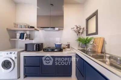 Modern kitchen with sleek blue cabinets and appliances