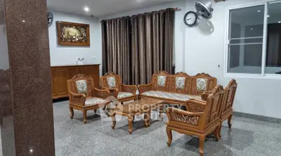 Elegant living room with classic wooden furniture and polished stone flooring