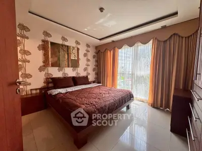Luxurious bedroom with elegant decor and large window offering natural light.