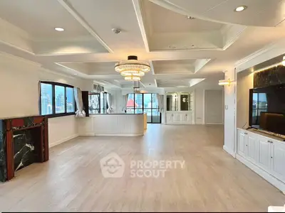 Spacious luxury living room with elegant chandelier and city view