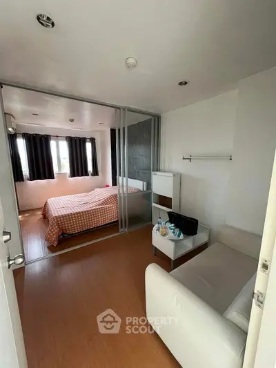 Modern bedroom with sliding glass doors and cozy seating area