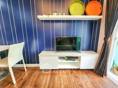 Modern living room with stylish blue accent wall and sleek TV setup
