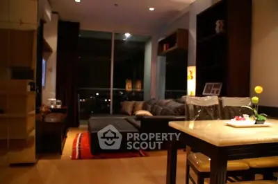Cozy living room with modern decor and city view, perfect for relaxation and entertainment.