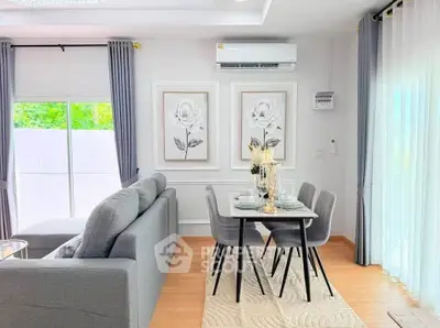Modern living room with elegant dining area, featuring stylish decor and natural light.