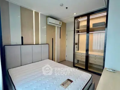 Modern bedroom with built-in wardrobe and air conditioning in a stylish apartment.