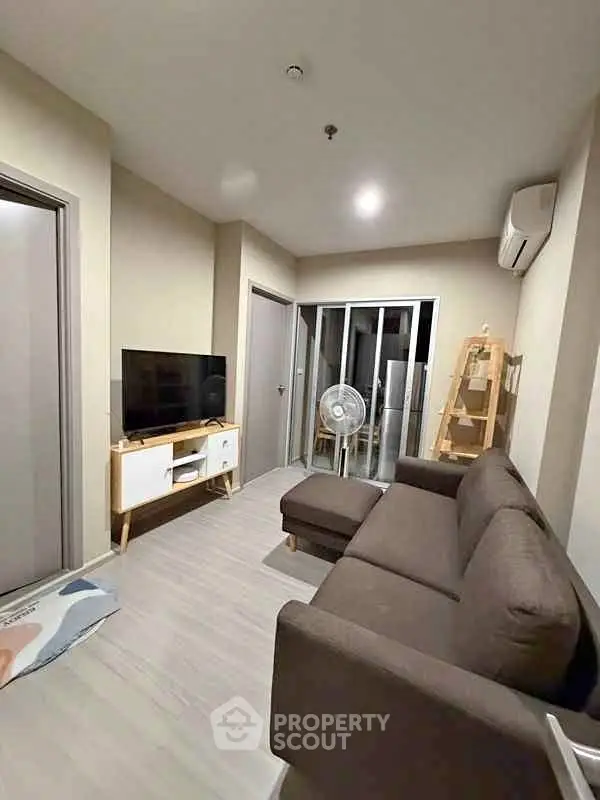 Modern living room with stylish furniture and sleek design, perfect for comfortable urban living.