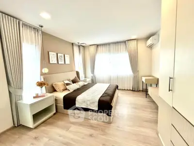 Spacious modern bedroom with elegant decor and natural light