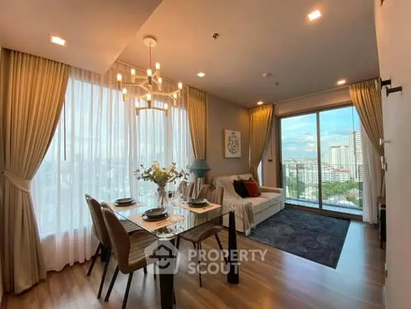Elegant living room with city view, modern decor, and dining area in a high-rise apartment.