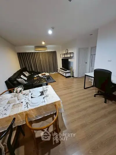 Spacious living room with modern decor and dining area, perfect for entertaining guests.