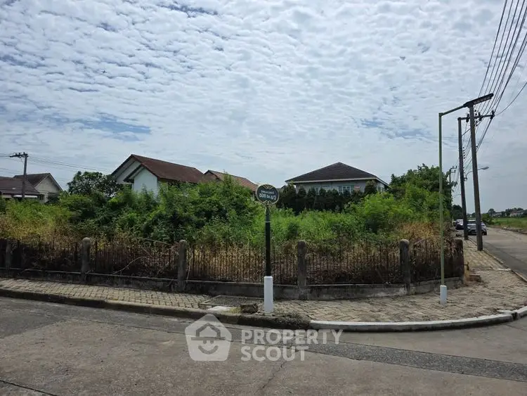 Corner plot of land with potential for development in a suburban neighborhood.