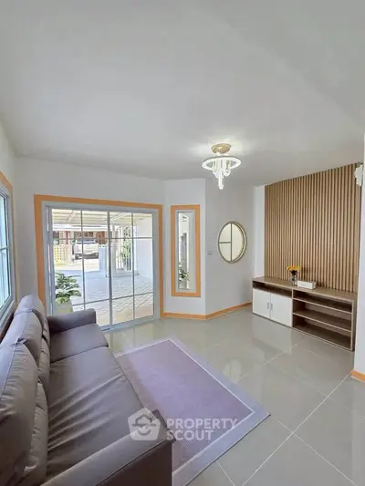 Modern living room with sleek design and natural light, featuring a cozy sofa and stylish decor.