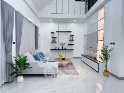 Modern living room with high ceiling, elegant decor, and stylish furniture in a luxurious home.