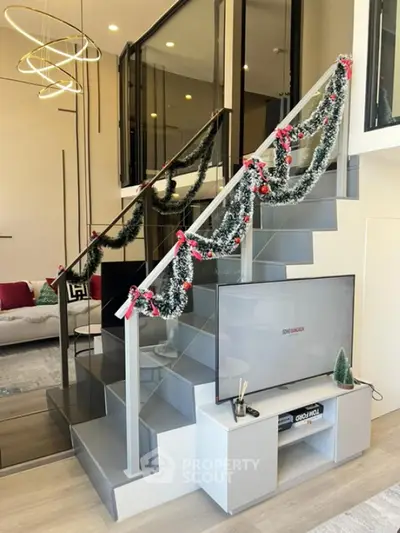 Modern duplex living room with stylish staircase and festive decor