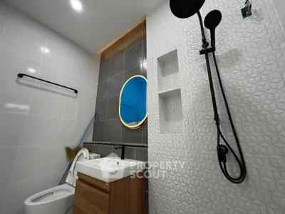 Modern bathroom with stylish fixtures and geometric tile design