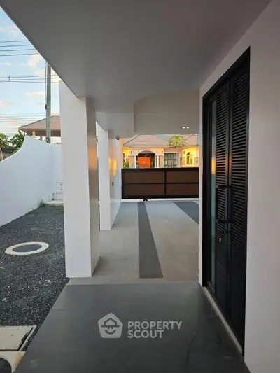 Modern house entrance with sleek design and spacious driveway