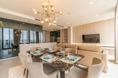 Luxurious open-plan living and dining area with elegant decor and stunning city views.